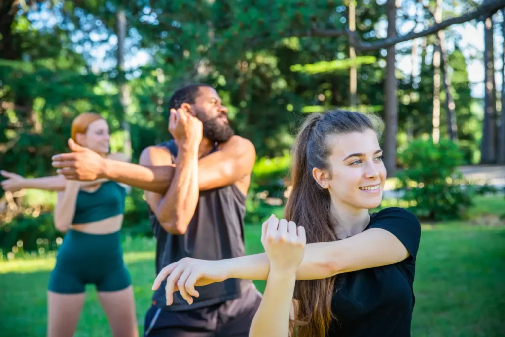 three athletes train and perform an arm stretch ex 2023 11 27 05 03 36 utc